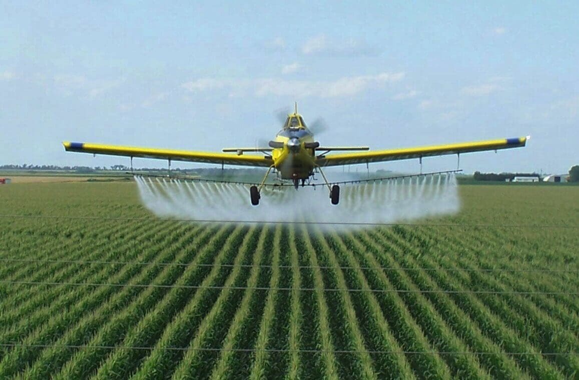 A crop duster spraying a field

AI-generated content may be incorrect.